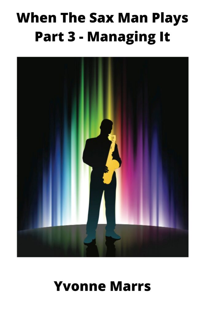 Silhouette of a saxophone player on stage with multicolour lights beaming down.